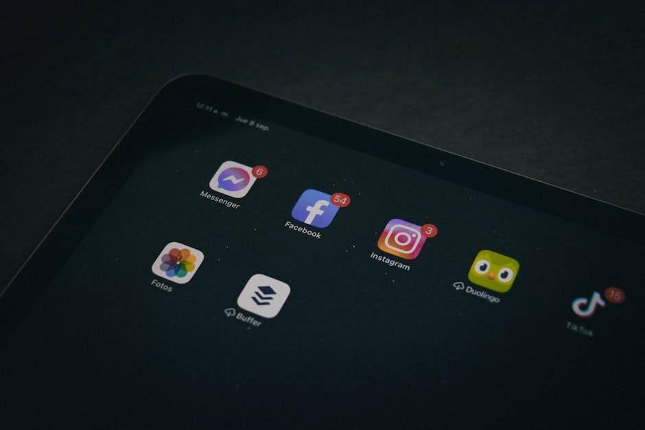 A tablet displaying popular apps like Facebook and Instagram in a dimly lit setting.