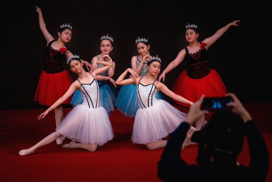 A group of ballerinas poses elegantly on stage, showcasing grace and poise for a performance.