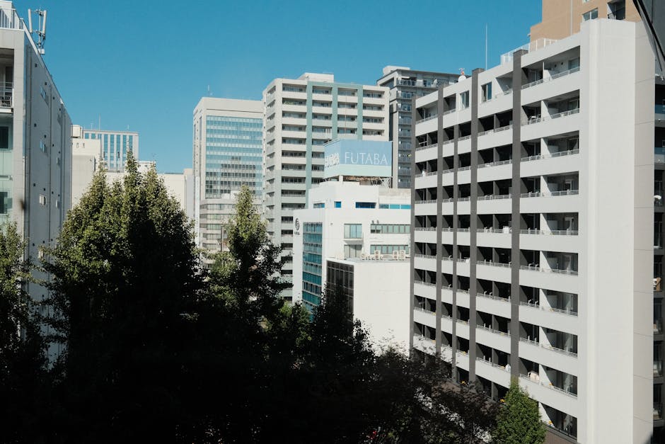 High-rise buildings against a blue sky in Nagoya, Aichi, Japan's urban landscape.