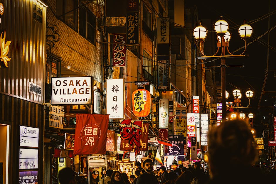 Bustling nightlife in Osaka's Dotonbori, Japan, featuring vibrant signage and a lively street atmosphere.