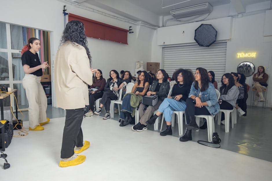 Group of diverse adults attending an indoor creative workshop, listening attentively.
