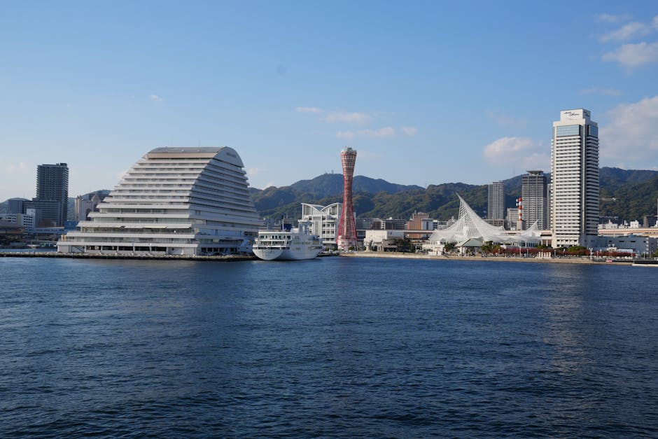 View of Kobe Port skyline featuring iconic harbor tower and modern architecture.
