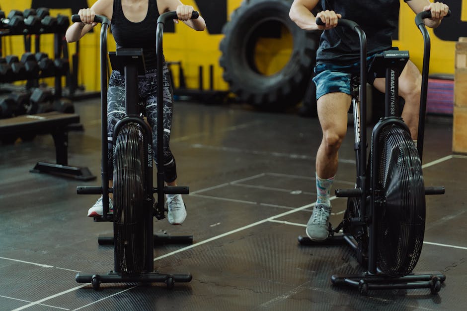 Two people exercising on stationary bikes at a modern gym.