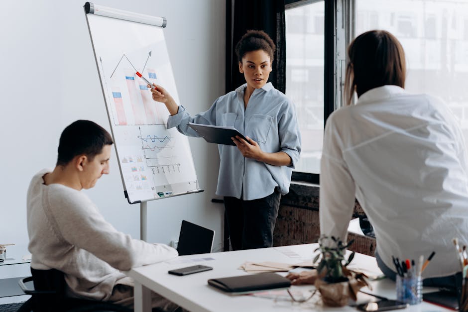 Business team discussing strategy with a presentation in a modern office setting.