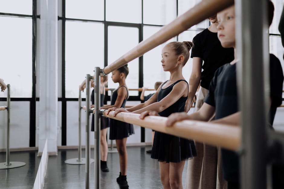 Children practicing ballet at a dance studio, focused and dedicated.