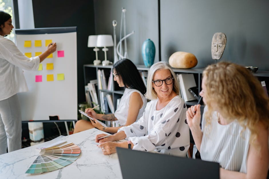 Diverse women collaborating in a stylish office during a creative brainstorming session with post-it notes.