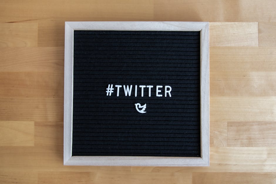 Black letter board with #Twitter hashtag and bird icon, ideal for social media themes.