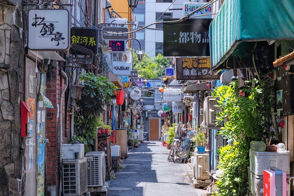 Explore a vibrant alleyway filled with bars and signs in Shinjuku, Tokyo, showcasing Japan's lively culture.