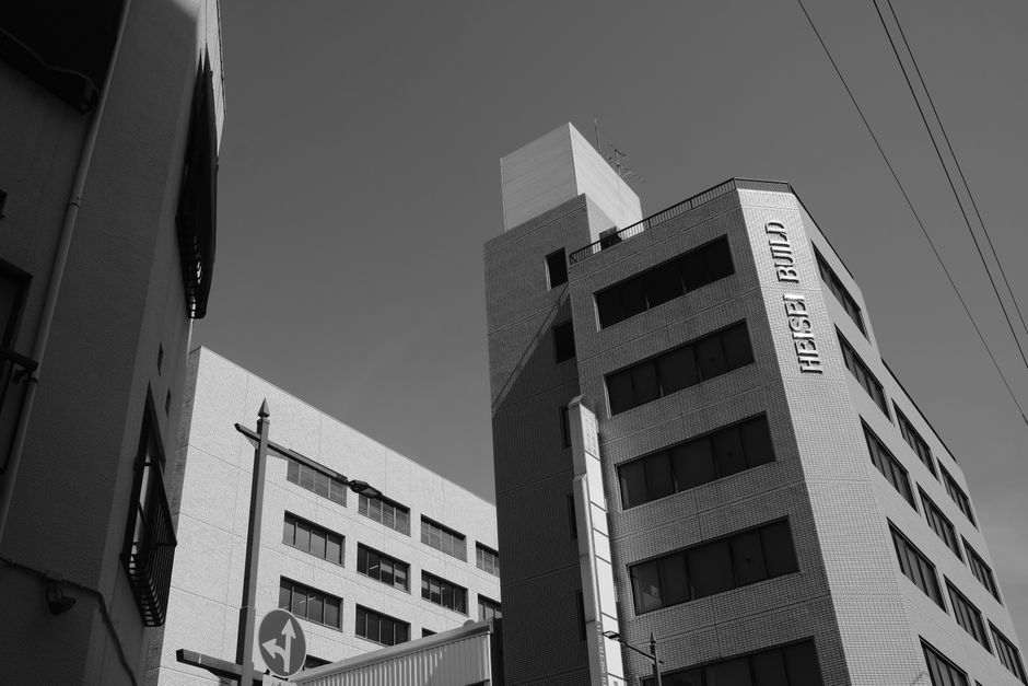 A black and white photo capturing modern urban architecture with bold lines and textures.