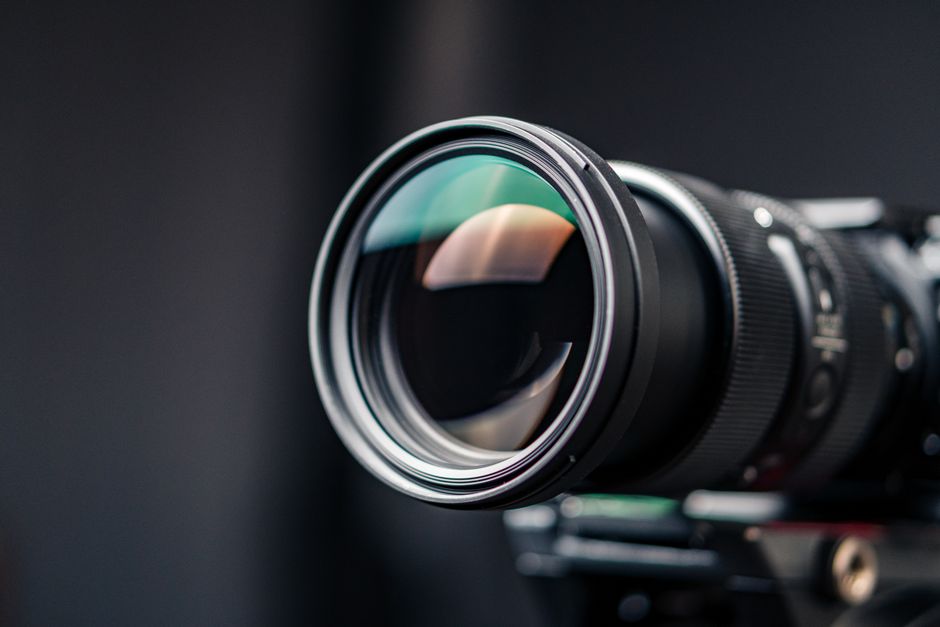 Detailed close-up of a professional camera lens with clear reflections.