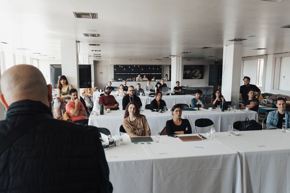 A diverse group of business professionals attending a presentation in a modern conference room.