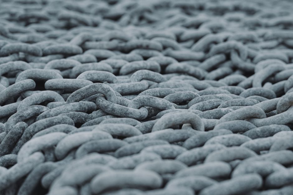 Detailed view of intertwined steel chains creating a rugged texture.