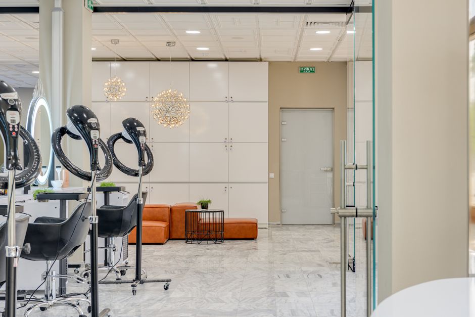 Stylish hair salon with sleek chairs, mirrors, and marble flooring, exuding a modern vibe.